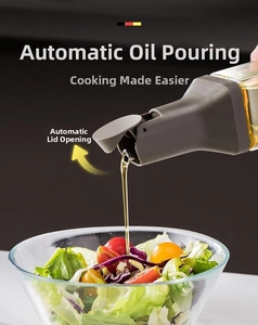 Detail of automatic gravity lid opening and oil pouring onto a fresh salad mix
