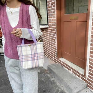 Plaid woolen handbag in purple and beige with woven handles and a gold metal clasp