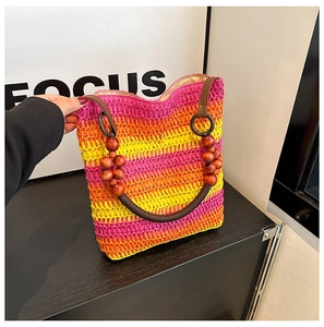 Detail of rainbow straw tote with vintage wooden bead handles and woven texture