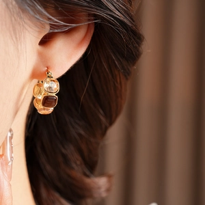 Detail of vintage square resin earrings with gold trim on model in Maillard style
