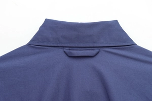 Detailed view of the navy blue shirt collar and twill fabric texture with clean stitching