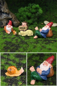Detail of colorful resin garden gnome set with hedgehog snail and dog figurines