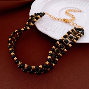 Detailed close-up of vintage beaded choker necklace with black crystals and gold-tone spacers