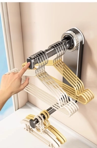 Detail of grey telescopic wall-mounted drying rack showing two-stage adjustable extension