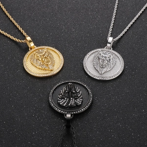 Detailed view of hip hop lion head circle pendants in gold, silver, and black finishes