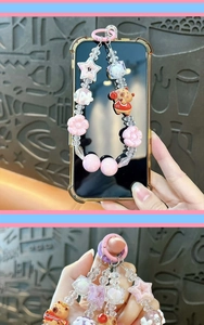 Macro view of a cute pink Capybara beaded phone charm with star and flower details