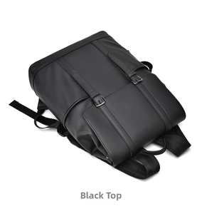 Top view of black leather backpack featuring dual decorative buckles and metallic fasteners