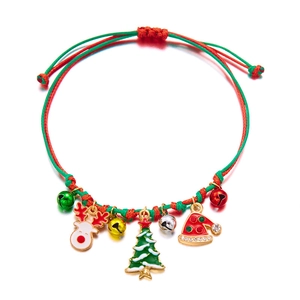 Close-up of handmade Christmas bracelet with woven rope and festive charms