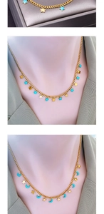 Detail showing moon and star pendants with blue drip oil finish on golden chains