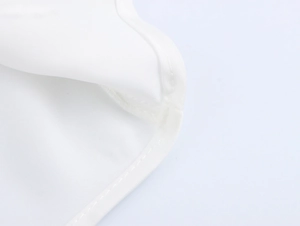 Close-up of high-quality stitching and smooth white fabric texture on this elegant dress