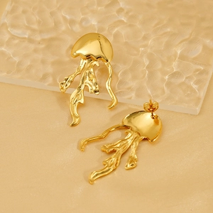 Golden jellyfish stud earrings with liquid metal texture on ripple glass background