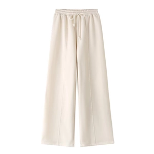 Detail of cream white high-waisted wide-leg trousers with drawstring and elastic waist
