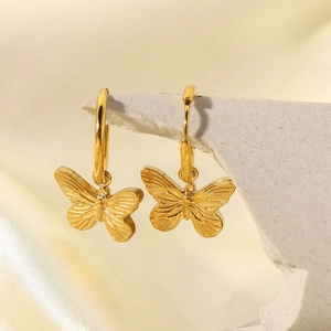 18K gold plated stainless steel butterfly drop earrings with pearls on silk background