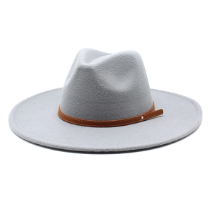 Detail of wide brim light grey felt fedora with brown leather strap and metal studs