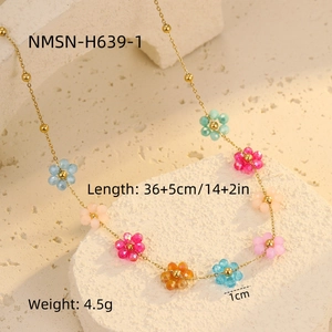 Detailed macro view of gold necklace with colorful crystal flowers and size parameters