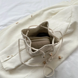 Floral tweed bucket bag with drawstring closure and soft cotton shoulder strap