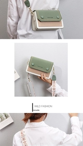 Detail of color-block leather crossbody bag with floral embroidery wide shoulder strap