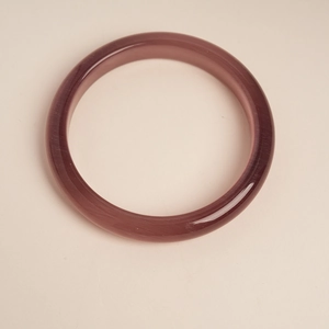 Macro detail of purple cat-eye stone bangle with silk luster finish for women