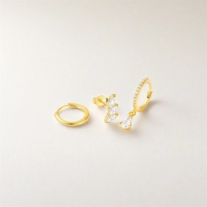 Detailed macro of gold S925 sterling silver three-piece earring set with turquoise stones