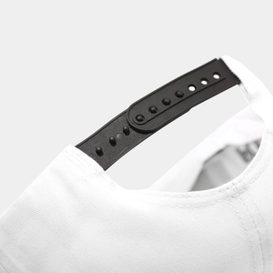 Detail view of the black snapback closure and white twill fabric on the hip hop cap