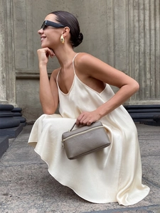 Elegant champagne satin slip mini dress paired with a luxury grey leather handbag