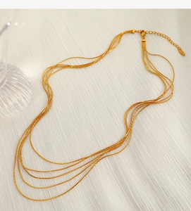 Detail of multi-layered gold snake chain necklace with adjustable lobster clasp
