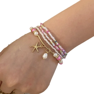 Handmade bead bracelet set with starfish and pearl charms in pink and gold tones