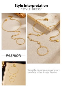 Macro detail of gold-plated hand harness with geometric crystals on stone background