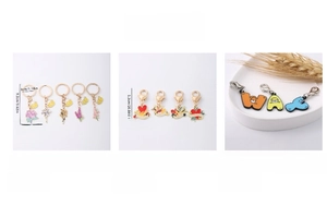 Detail of bee, floral and heart-shaped alloy pendants with enamel drip oil finish
