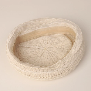 Beige knitted beret for women showing soft texture and inner sweatband detail