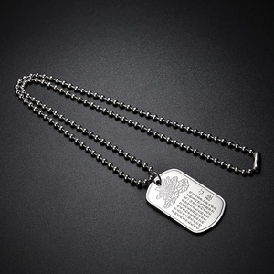 Detailed close-up of engraved lotus and Buddhist Heart Sutra on silver titanium pendant