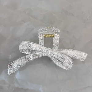 Transparent bow hair claw with white lace pattern and gold metal spring closure