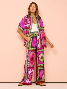 Detail of floral print summer set with short sleeve shirt and wide leg trousers