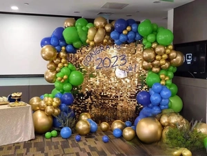 Detail of square gold sequin wall panel with balloon arch for 2023 party celebration