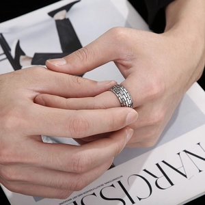 Close-up of men's punk style ring with unique irregular brick texture on finger