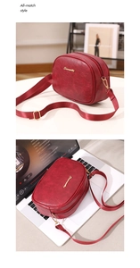Detail view of wine red oil wax leather crossbody bag with golden zipper and fabric strap