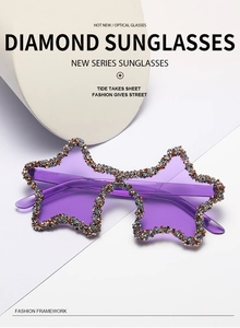 Detailed view of purple star-shaped sunglasses with hand-set rhinestones and luxury finish