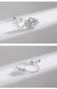 Detailed view of silver adjustable chain ring with sparkling cubic zirconia flower motif