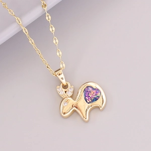 Detail of 18K gold zodiac rabbit pendant featuring sparkling crystals and a colorful opal heart