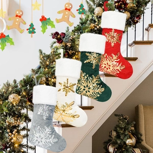 Set of four plush Christmas stockings in red, green, white, and grey with gold snowflake sequins