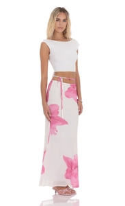 Detail of white tie-waist mesh skirt featuring pink floral print and side slit design