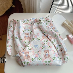 Detail of canvas tote bag with brown bear, pink roses and blue bows pattern