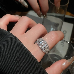 Detail of silver-plated bow ring featuring full pavé zircon stones and cut-out design