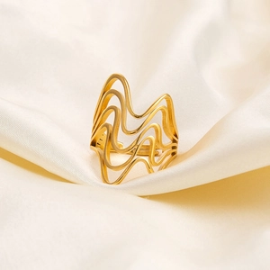 Macro detail of wave texture on irregular 18K gold-plated adjustable stainless steel ring
