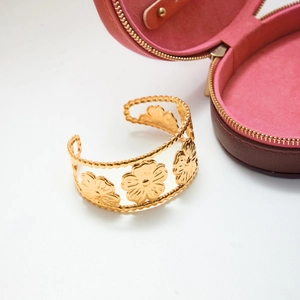 Detailed view of 18K gold stainless steel open bangle with embossed flower pattern