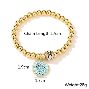 Close-up of 18K gold-plated beaded bracelet with blue evil eye charm and size specs