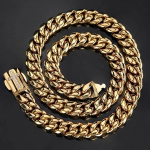 Gold-plated Cuban link necklace with rhinestone cross clasp on a black background