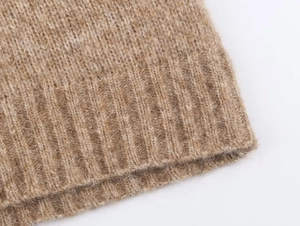 Close-up detail of the camel wool knit fabric showing ribbed texture and soft wool fibers
