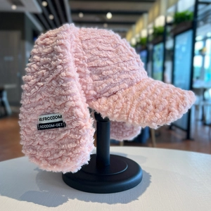 Pink plush bunny ear baseball hat with earflaps and soft faux fur texture for winter