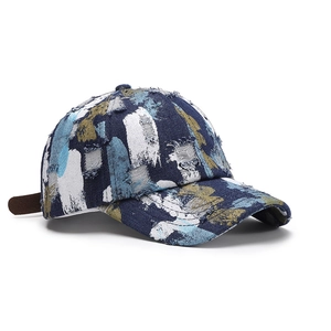 Distressed camouflage baseball cap with paint splatter effect and frayed edge details